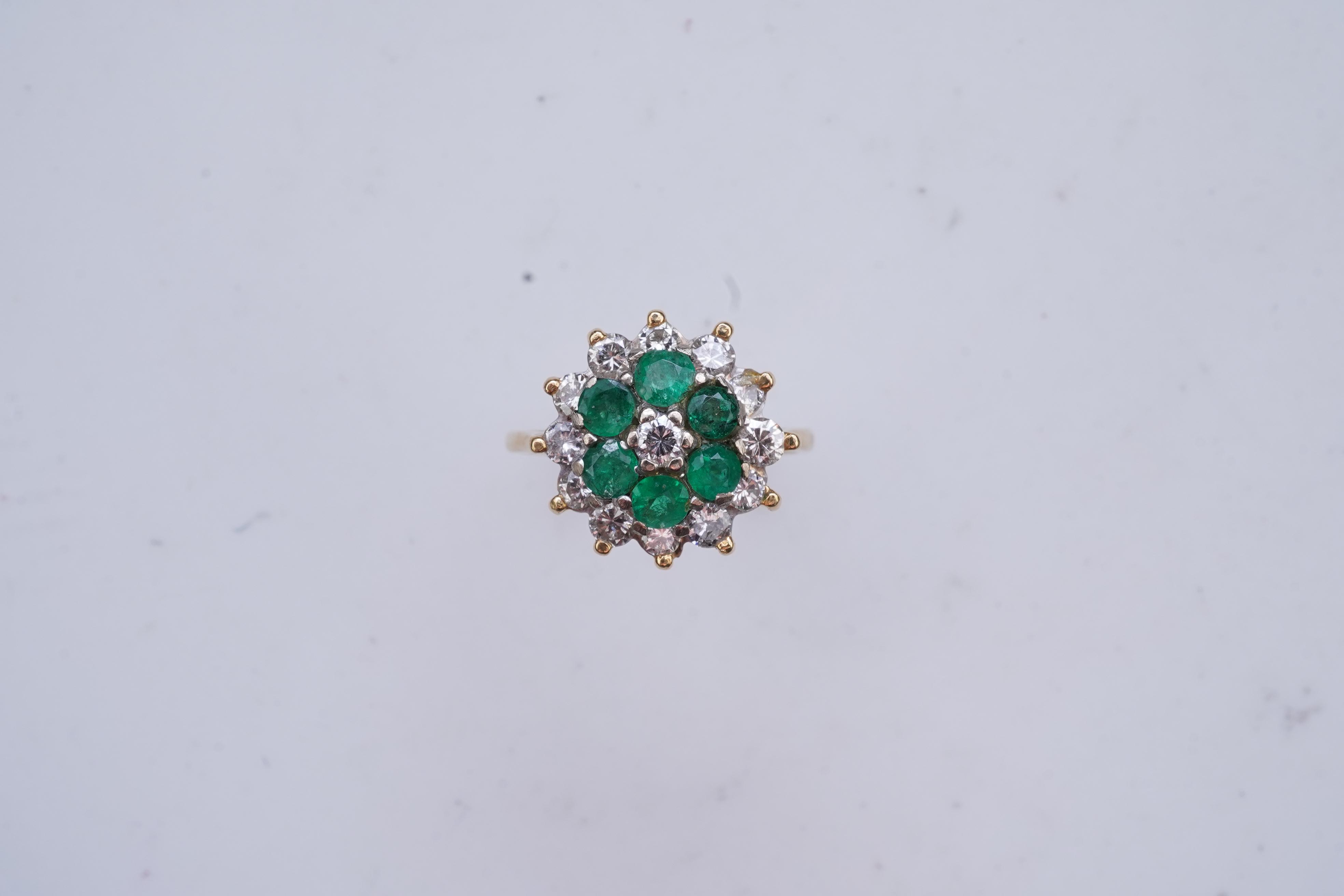 An emerald and diamond ring